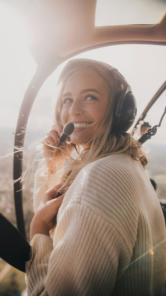 A girl pilot flying a helicopter.